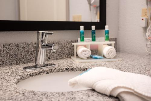 a bathroom sink with a towel and a faucet at Holiday Inn Express & Suites Alamogordo Highway 54/70 by IHG in Alamogordo