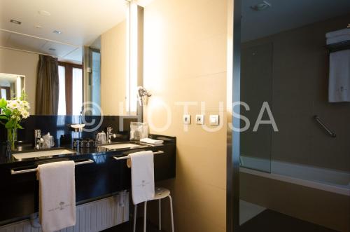 a bathroom with a sink and a mirror at Gran Hotel La Perla in Pamplona