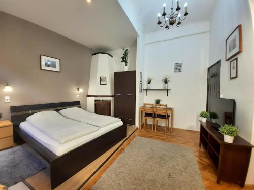 a bedroom with a large bed and a desk at Central Gold Apartment in Budapest