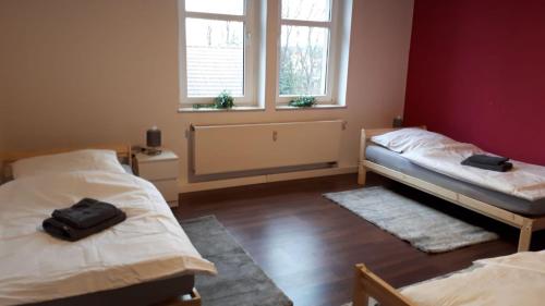 a room with two beds and a window at cosy apartment in Neupetershain with Wifi in Neupetershain