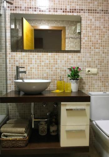 a bathroom with a sink and a mirror at Varosha Combarro in Combarro