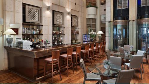 a bar in a restaurant with chairs and tables at Crowne Plaza Haifa by IHG in Haifa