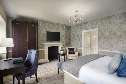 a bedroom with a bed and a desk and a chair at Ensana Buxton Crescent in Buxton