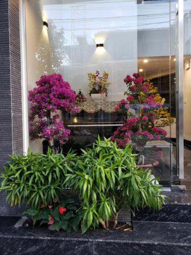 a display of flowers and plants in a window at Biên Hòa Hotel in Bien Hoa