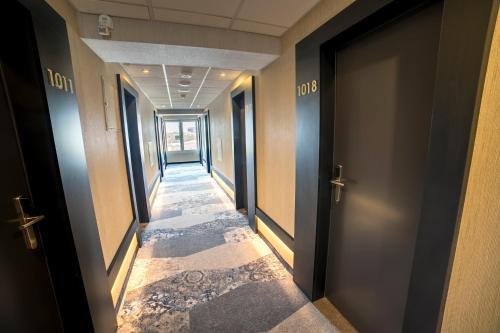 a corridor of an office with doors and a hallwayngth at Hotel Victoria in Lublin