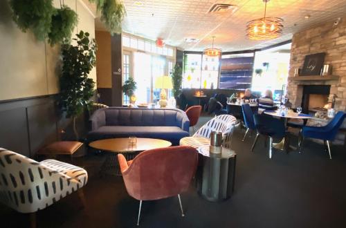 a restaurant with couches and tables and chairs at Inn on Main Hotel in Manasquan