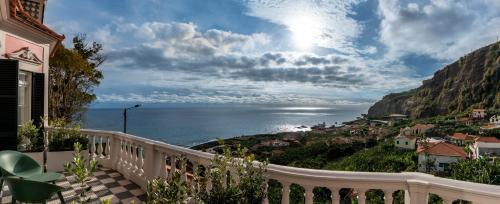 a balcony with a view of the ocean at 1905 Zino's Palace in Ponta do Sol