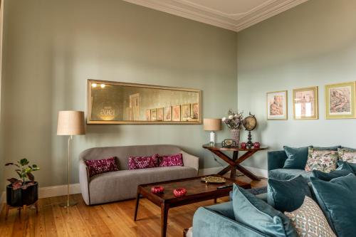 a living room with a couch and a table at 1905 Zino's Palace in Ponta do Sol