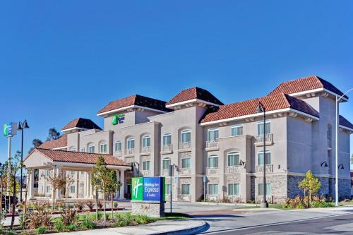 a large white building with a red roof at Holiday Inn Express Hotel & Suites Banning by IHG in Banning