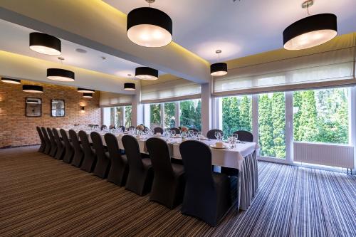 a conference room with a long table and chairs at Hotel Almarco in Środa Wielkopolska