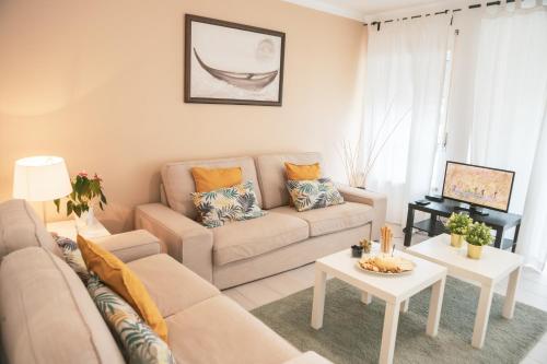 a living room with a couch and a table at Marlin House in Baleal