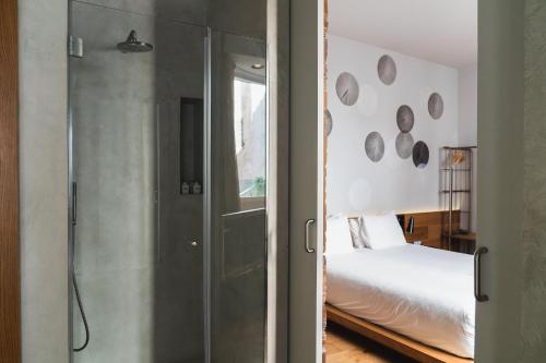 a bedroom with a glass door leading to a bed at Puro Hotel Oasis Urbano in Palma de Mallorca