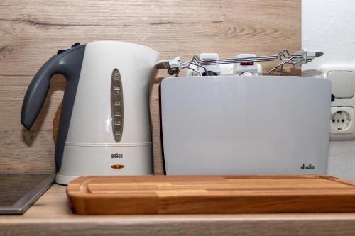 a coffee maker and a toaster on a counter at BIT-City Studio und Appartement in Bitburg