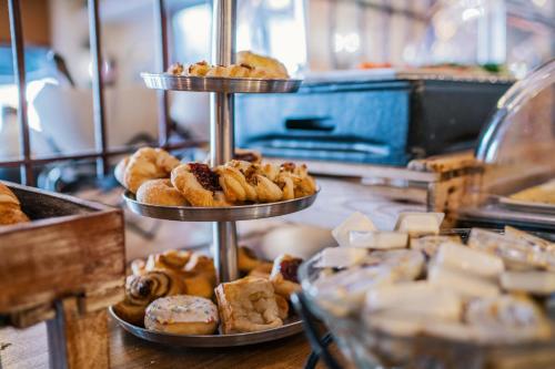 two tiered plates of pastries on a counter in a bakery at Martini Hotel in Groningen