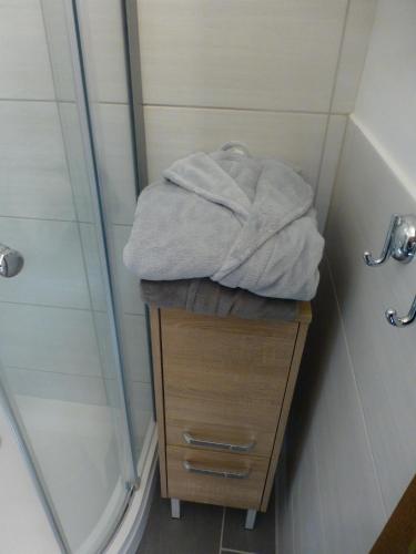 a pile of towels sitting on a table in a shower at BIT-City Studio und Appartement in Bitburg