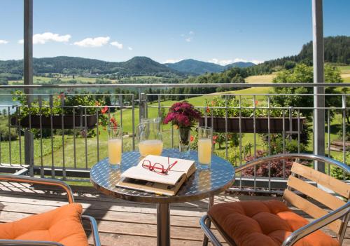 a table with a cake on top of a balcony at Hotel Seehof in Sankt Georgen am Längsee