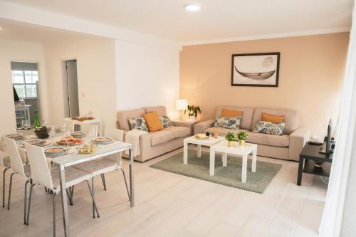 a living room with a couch and a table at Marlin House in Baleal