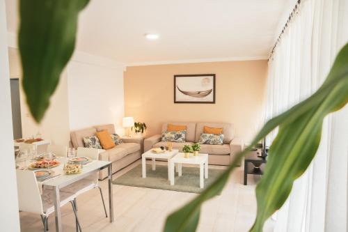 a living room with a couch and a table at Marlin House in Baleal