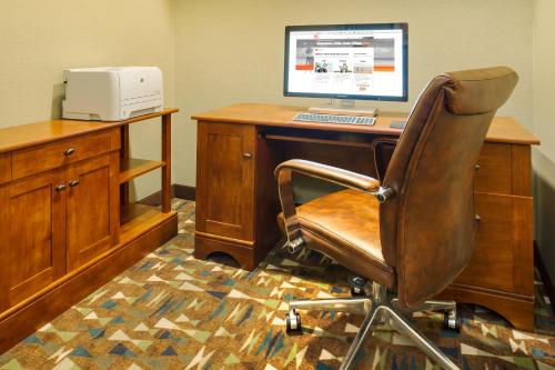 an office with a desk with a computer on it at Kalamazoo Hotel and Suites in Kalamazoo