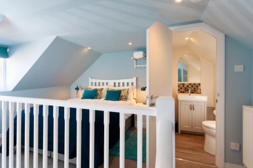 a childs bedroom with blue walls and a white crib at No 10 in Whitstable