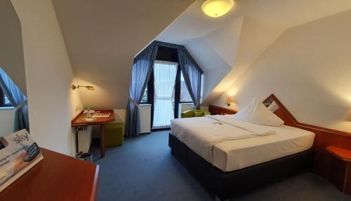 Postel nebo postele na pokoji v ubytování AKZENT Hotel Merfelder Hof