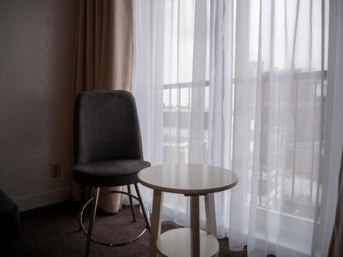 a chair and a table in front of a window at Hotel Hague Center in The Hague