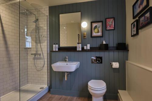 a bathroom with a sink and a toilet and a shower at The Bear Esher in Esher