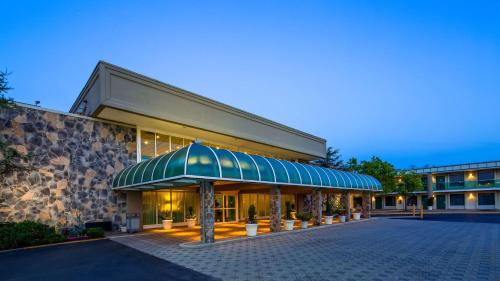 an exterior view of a hotel with a building at SureStay Plus Hotel by Best Western Brandywine Valley in Wilmington