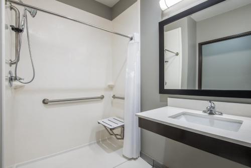 a bathroom with a sink and a shower and a mirror at Holiday Inn Express & Suites Stillwater - University Area, an IHG Hotel in Stillwater