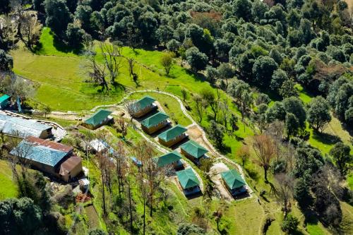 an aerial view of a house on a hill with trees at CBB - Camp Bir Billing in Bīr