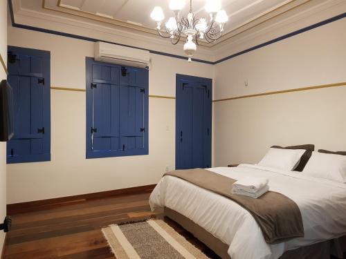 Cama ou camas em um quarto em Suite Família Inconfidentes