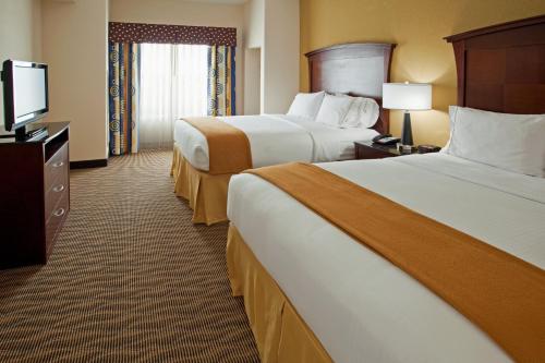 a hotel room with two beds and a flat screen tv at Holiday Inn Express & Suites Austin South-Buda by IHG in Buda