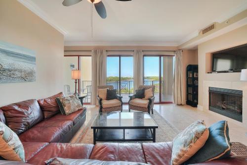 a living room with a couch and a table at Sanctuary by the Sea Condos in Santa Rosa Beach