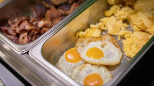 a meal with eggs and other food in a tray at Hotel Astoria in Karlsruhe