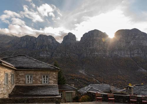 a view of a mountain range with a building in front at Papaevangelou Hotel in Papigko