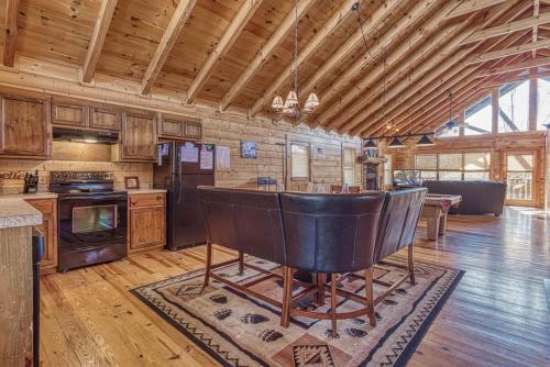 a kitchen with a bar in the middle of a room at Always and Forever-Hot Tub, Arcade, Near the Parkway! in Pigeon Forge