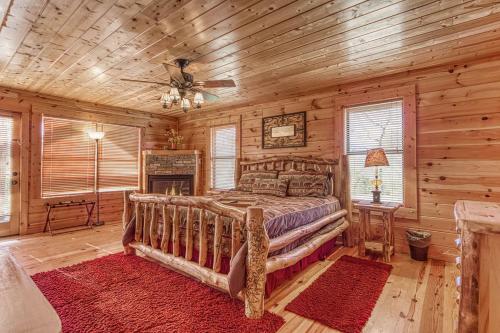 a bedroom with a bed in a log cabin at Always and Forever-Hot Tub, Arcade, Near the Parkway! in Pigeon Forge