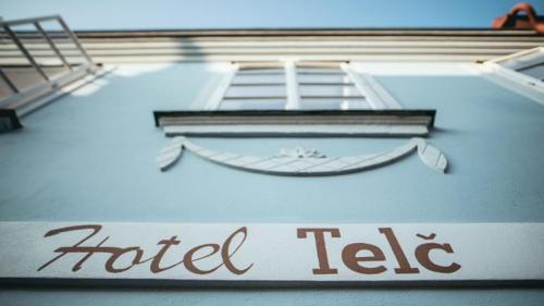 a sign on the side of a building at Hotel Telč in Telč
