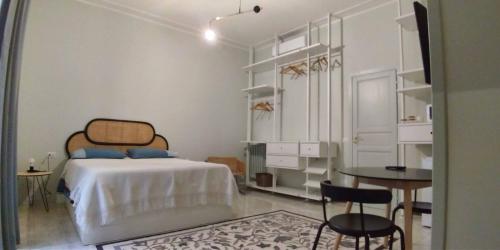 a bedroom with a bed and a table and chairs at La stanza di Camillo in Rome