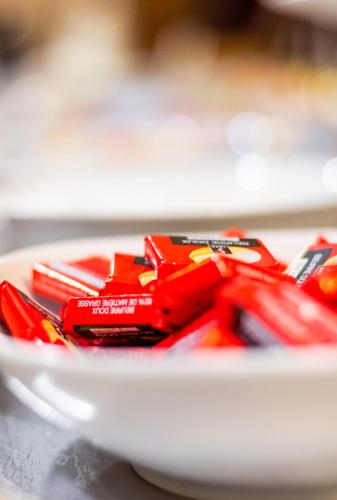a white bowl filled with red candy bars at initial by balladins La Roche-sur-Yon in La Roche-sur-Yon