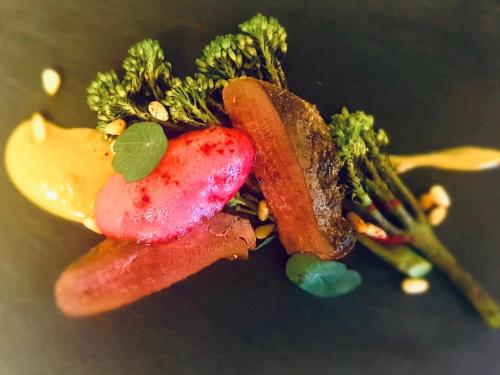a plate of food with broccoli and fruits and vegetables at The Chequers Inn in Froggatt