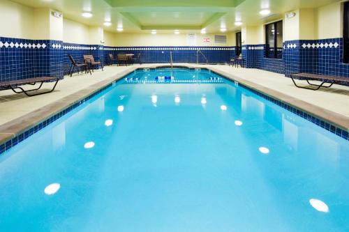 a large swimming pool with blue water at Holiday Inn Express Hotel & Suites Smyrna-Nashville Area, an IHG Hotel in Smyrna