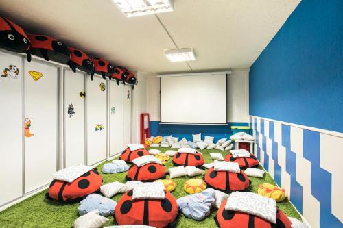a room with a bunch of beds with lady bugs at Melia Sierra Nevada in Sierra Nevada