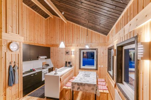 a kitchen with wooden walls and a wooden ceiling at Malin Resort in Abborrträsk