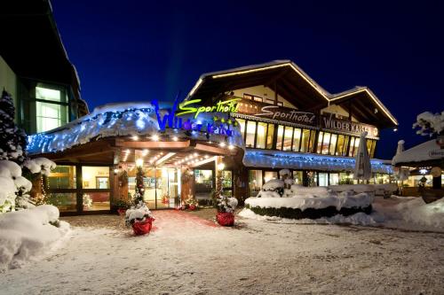 a building covered in snow at night at Sporthotel Wilder Kaiser in Oberaudorf