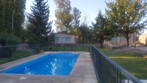 a swimming pool in a yard with a fence at Finca Casiana in Villa Krause