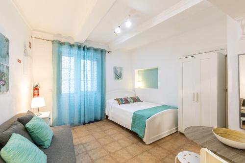 a bedroom with a bed and a couch at Faro Downtown Ria Formosa I in Faro