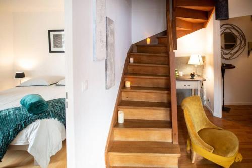 - une chambre avec un escalier à côté d'un lit et d'un escalier dans l'établissement Duplex tout équipé, proche centre-ville COLMAR, parking, à Colmar
