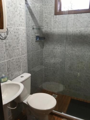 une salle de bain avec toilettes, lavabo et douche dans l'établissement Casa Sossego da Montanha, à Visconde de Mauá