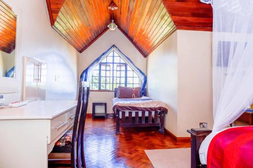 a room with a window and a chair in it at Orchid Homes, Gigiri in Nairobi